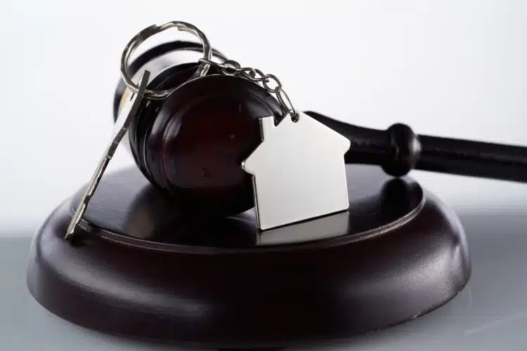 Gavel and house key on the table