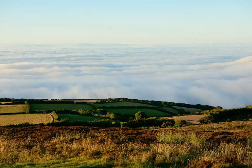 a view of fields against clouds