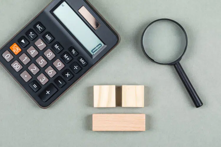 a calculator and magnifying glass on a table