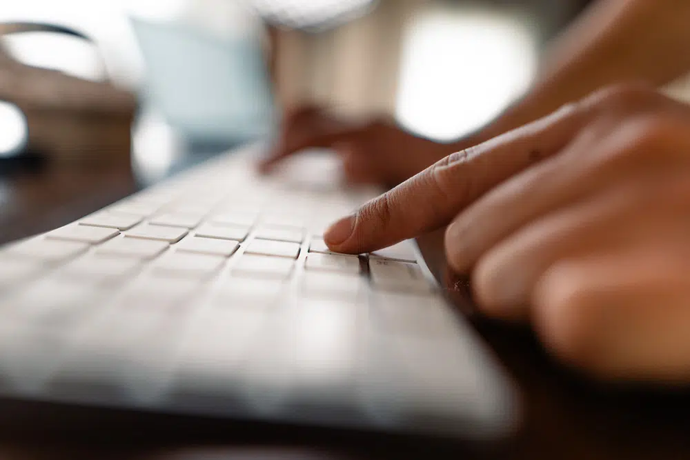 close up of accountant typing on a keyboard