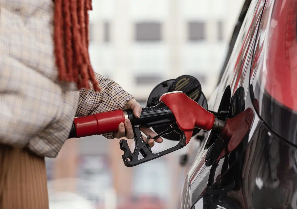 person filling up their car with fuel