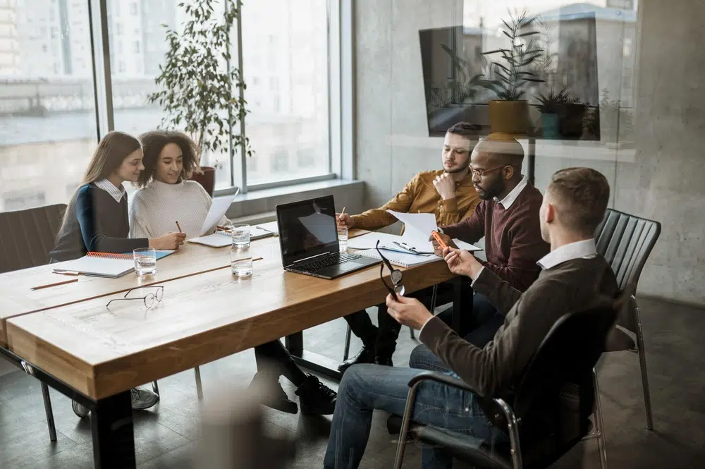 people sat at a table having a meeting