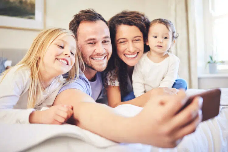 a family sat taking a selfie together