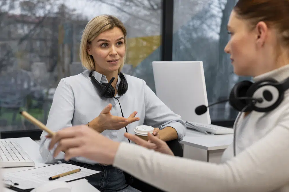 two agents discussing a work call